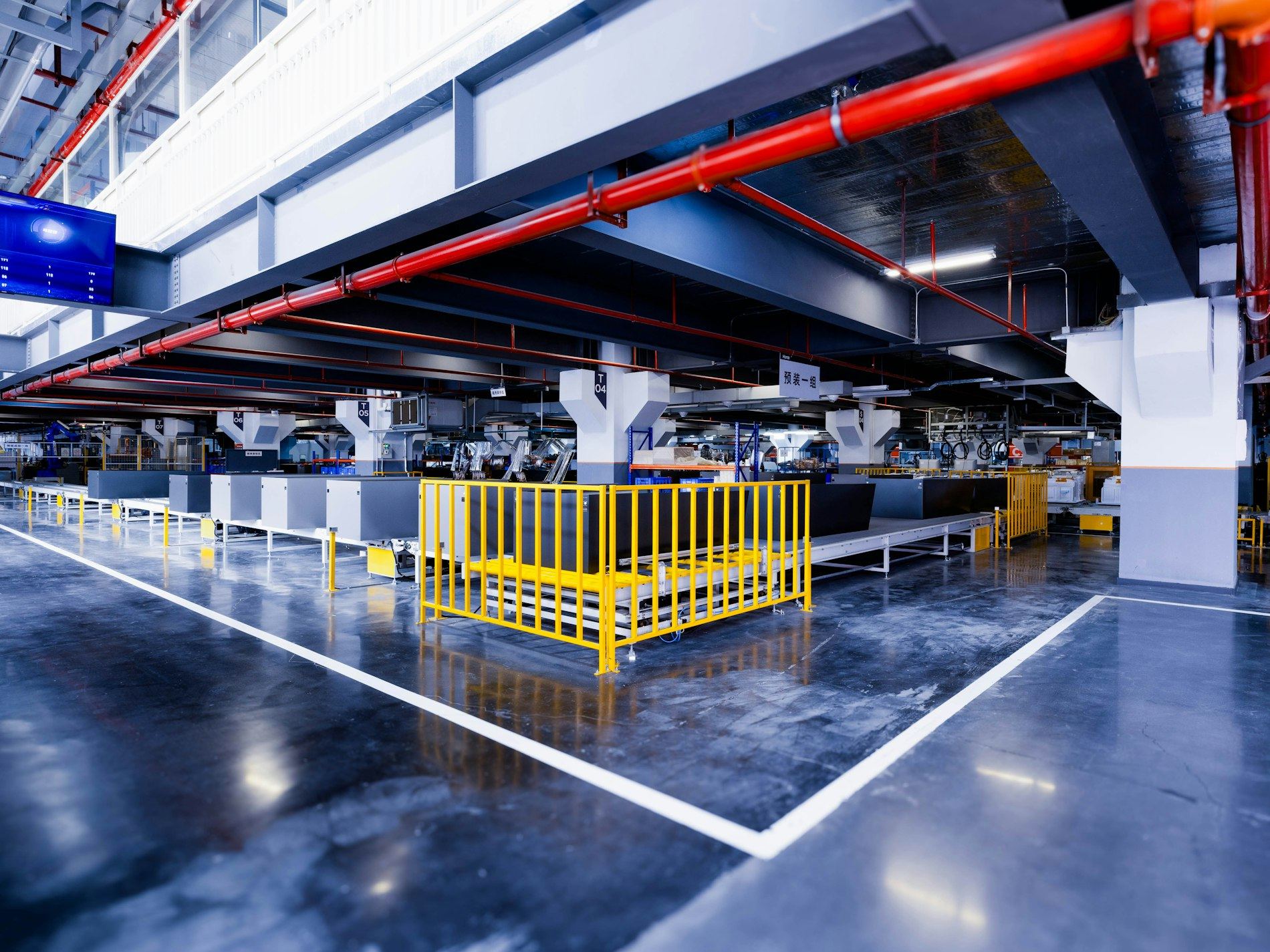Industrial warehouse interior with glossy floor and yellow safety railing