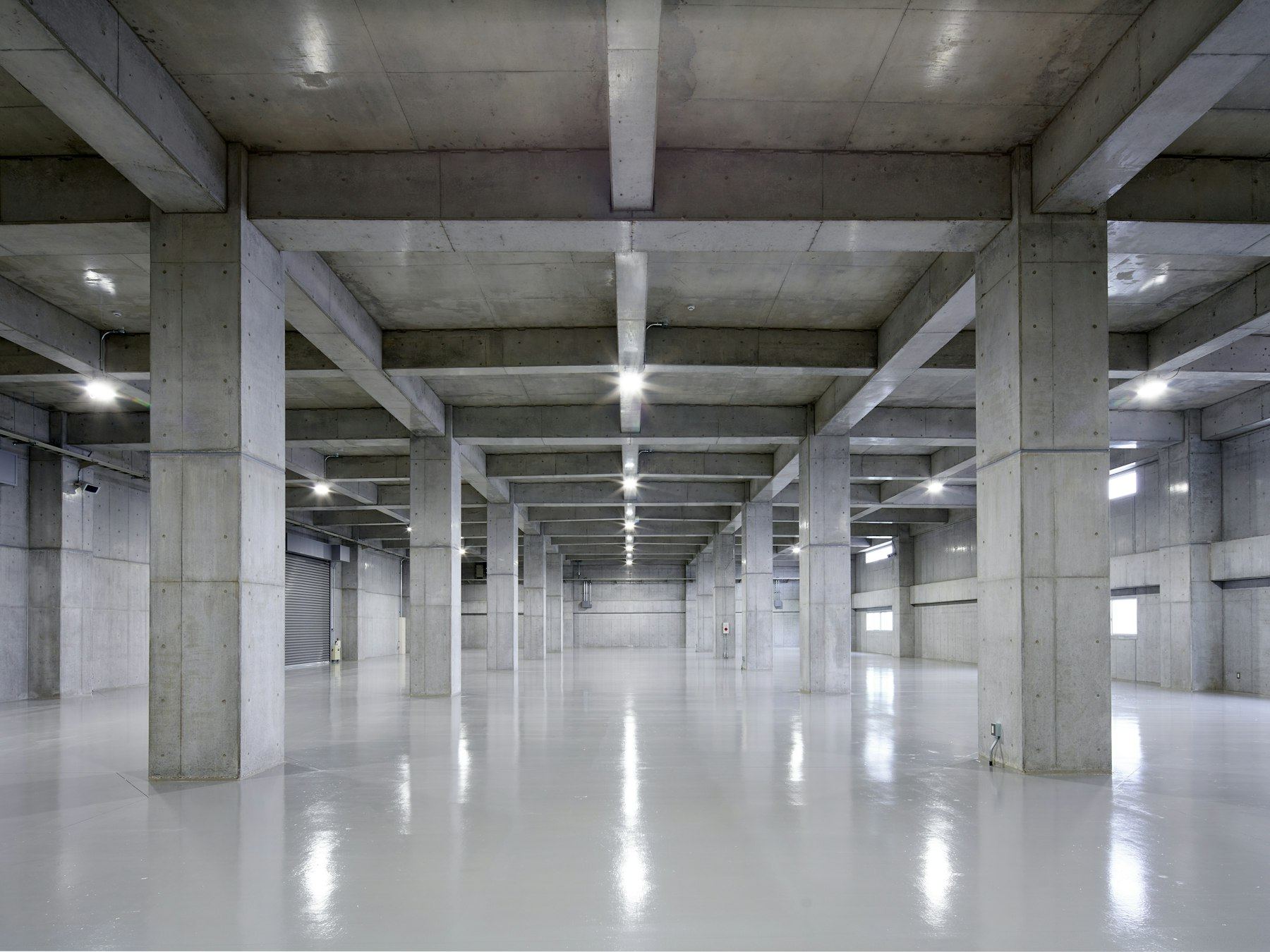 Empty concrete parking garage with polished floor and natural light